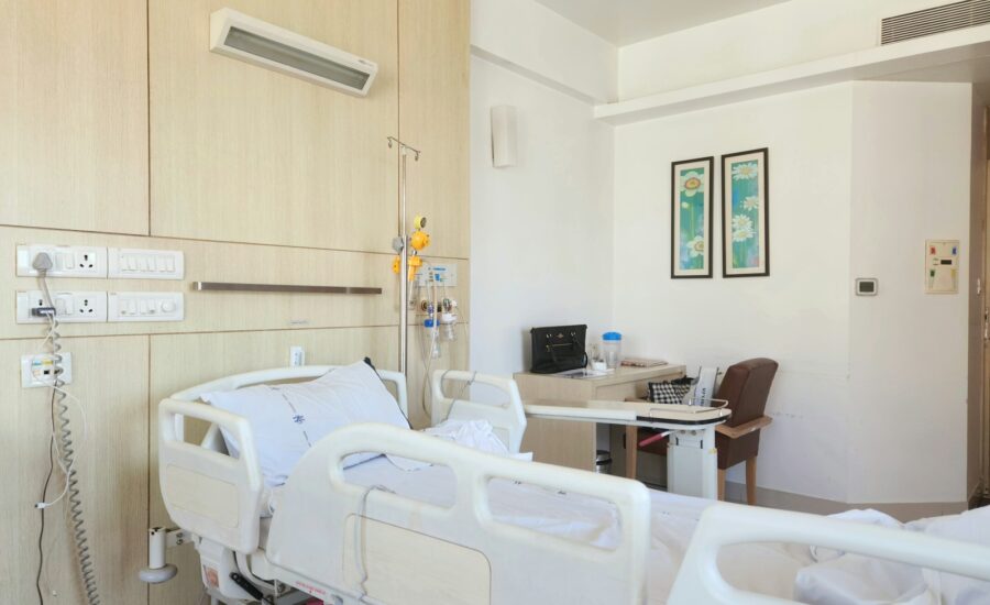a hospital room with a bed and a desk