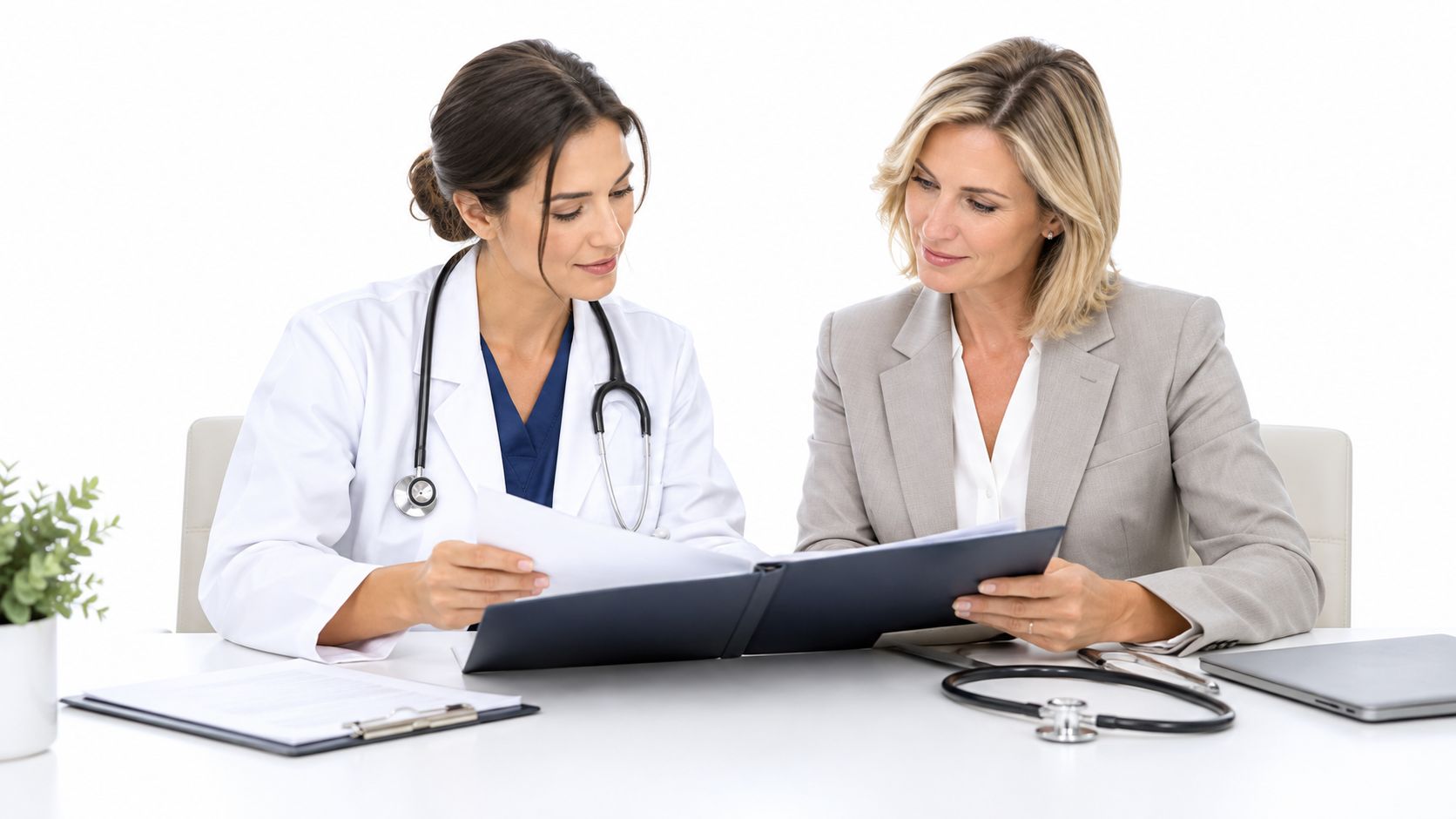 A female doctor in a white coat consulting with a professional woman over medical documentation in office.